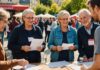 Bénévolat associatif : qui sont les Français engagés et pourquoi recruter devient plus difficile Groupe de bénévoles associatifs de tous âges échangeant lors d'un événement en France